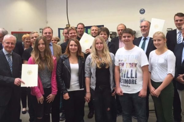 Gruppenbild von der Bescheidübergabe in der Metall- und KFZ-Werkstatt der Dorstener Arbeit.